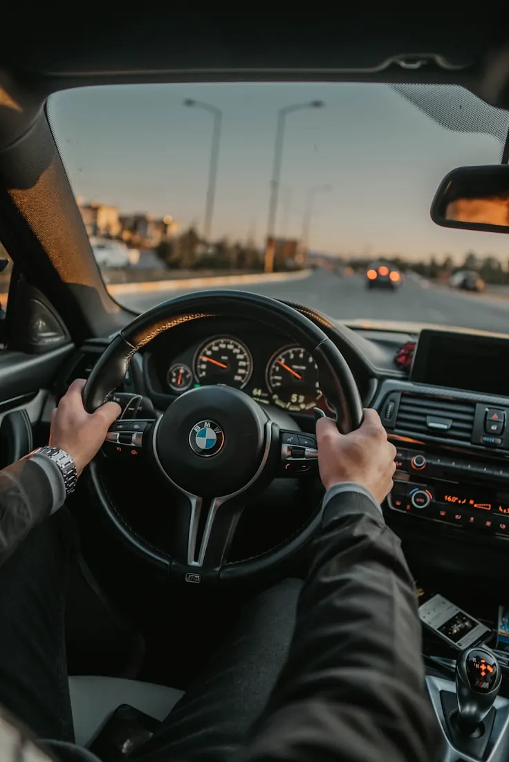 A driver behind the steering wheel, symbolizing lawful and attentive driving